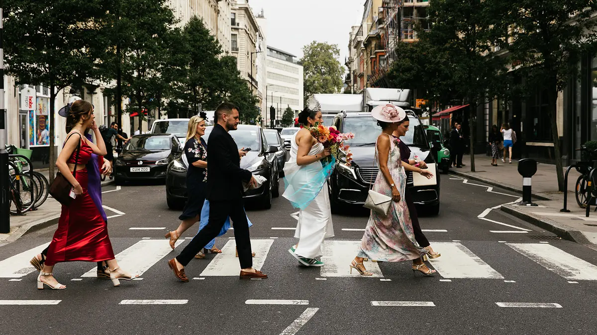 A wedding party crossing a London street