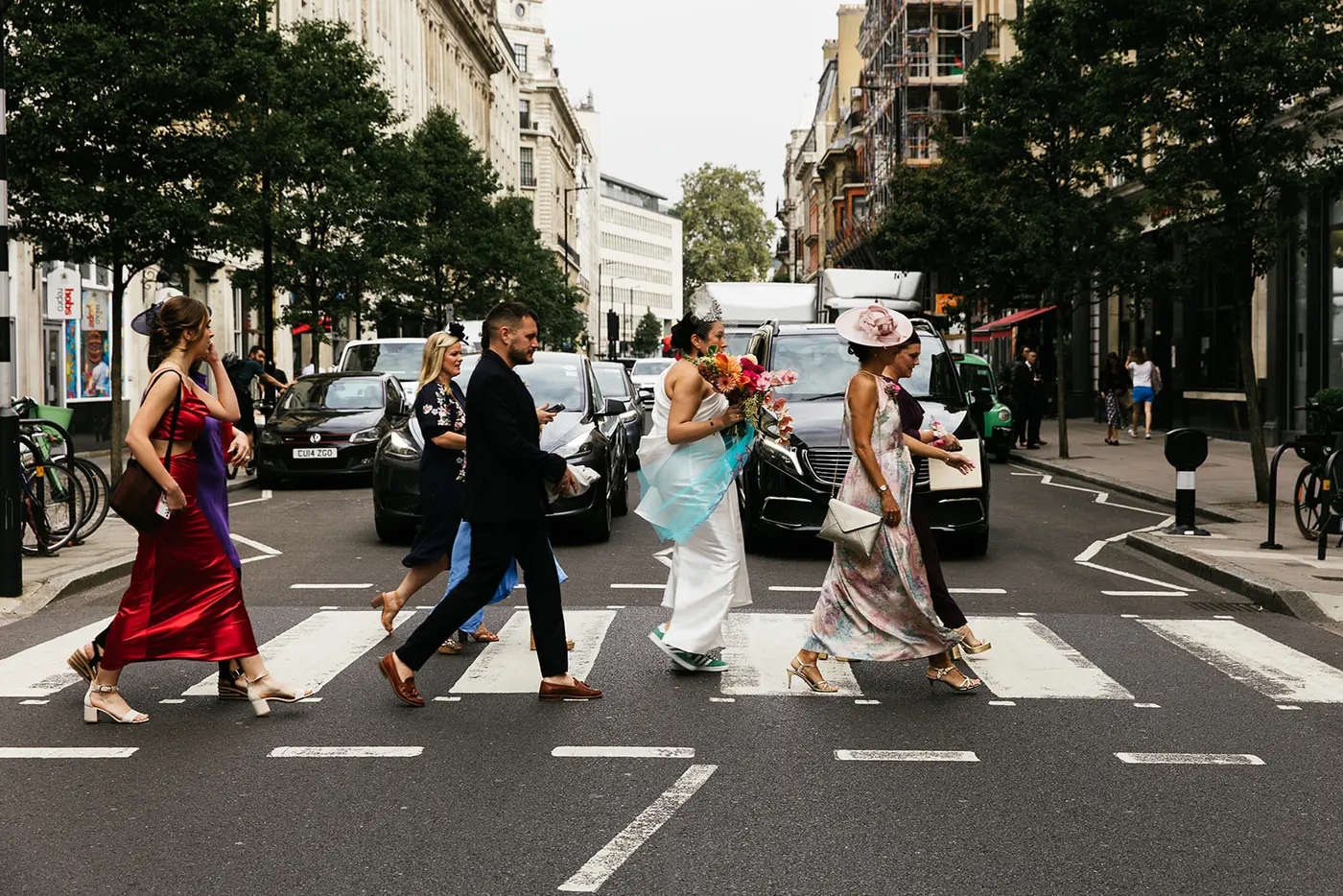 A wedding party crossing a London street